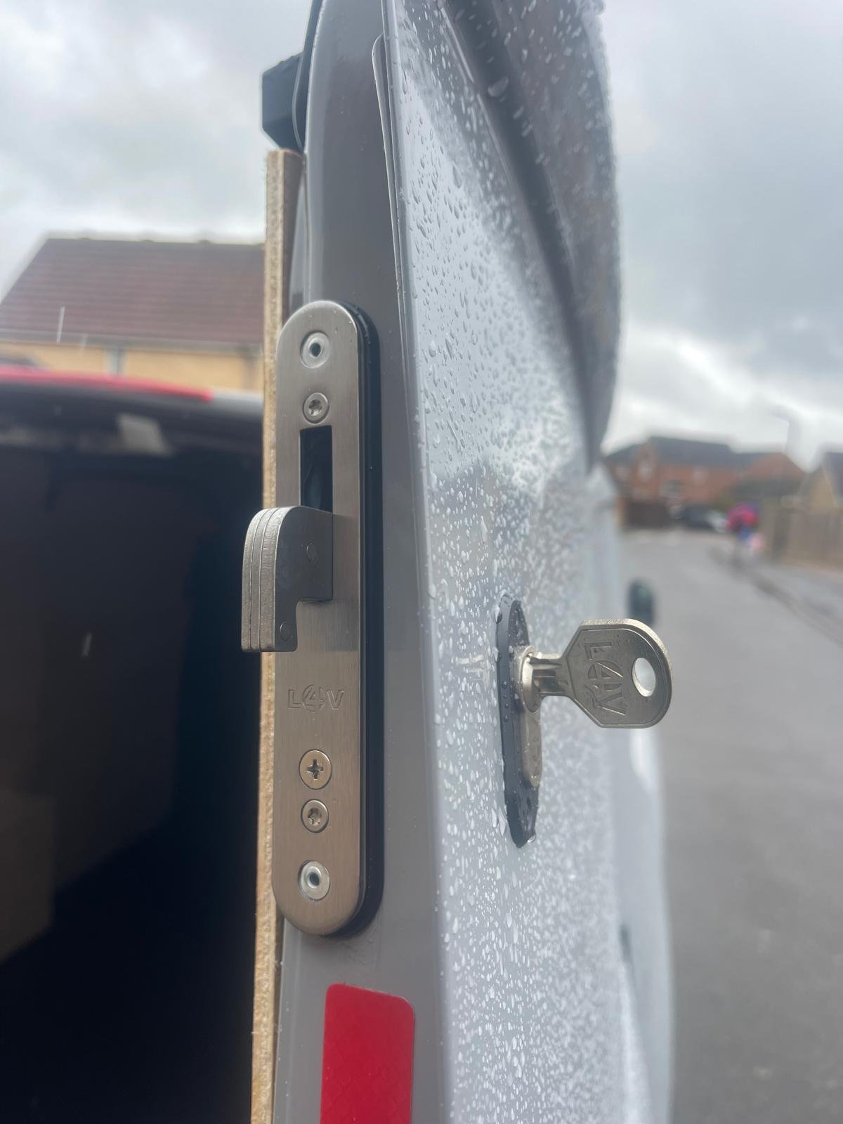 Close-up of a hook deadlock striker plate and key